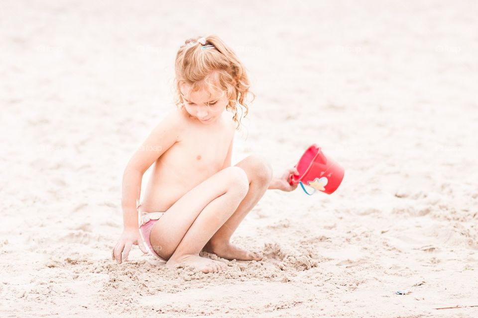 Girl playing on the beach