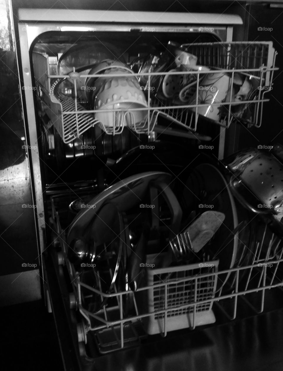 messy dishes waiting to be washed in an open dishwasher