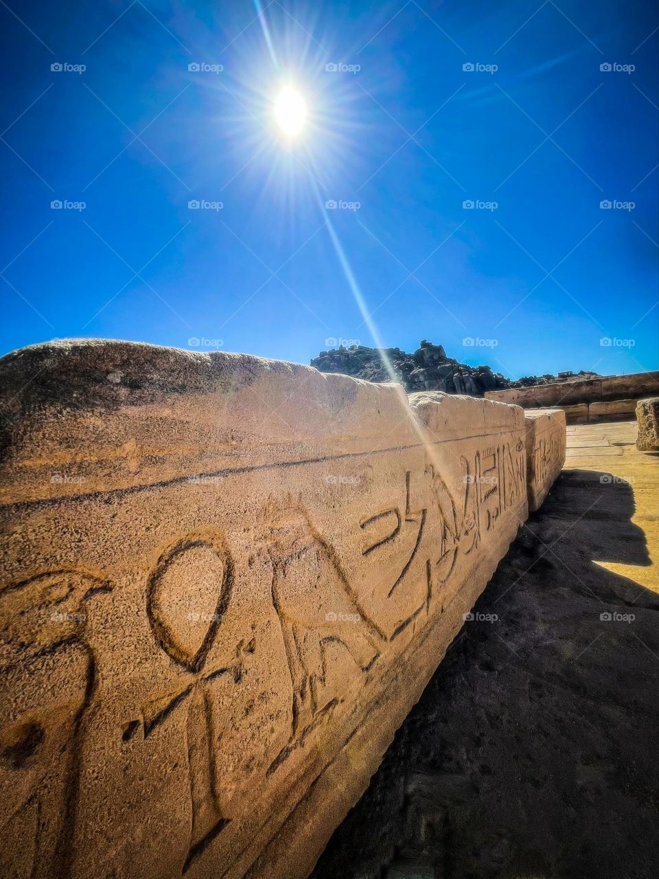 Sunglare over a horizontal obelisk at the Philae Temple on Aswan, Egypt.