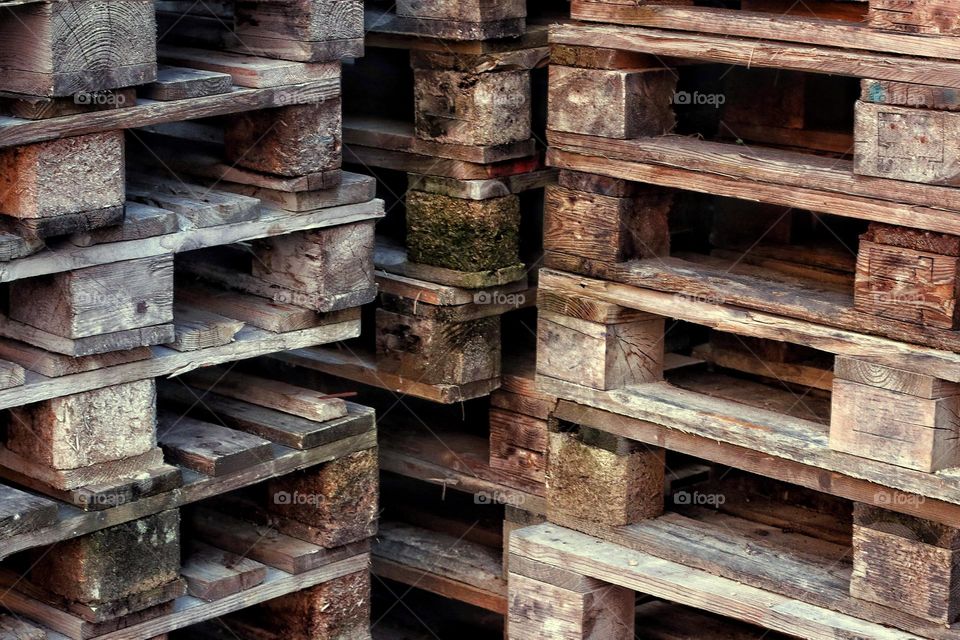 Stacked brown rough wooden pallets