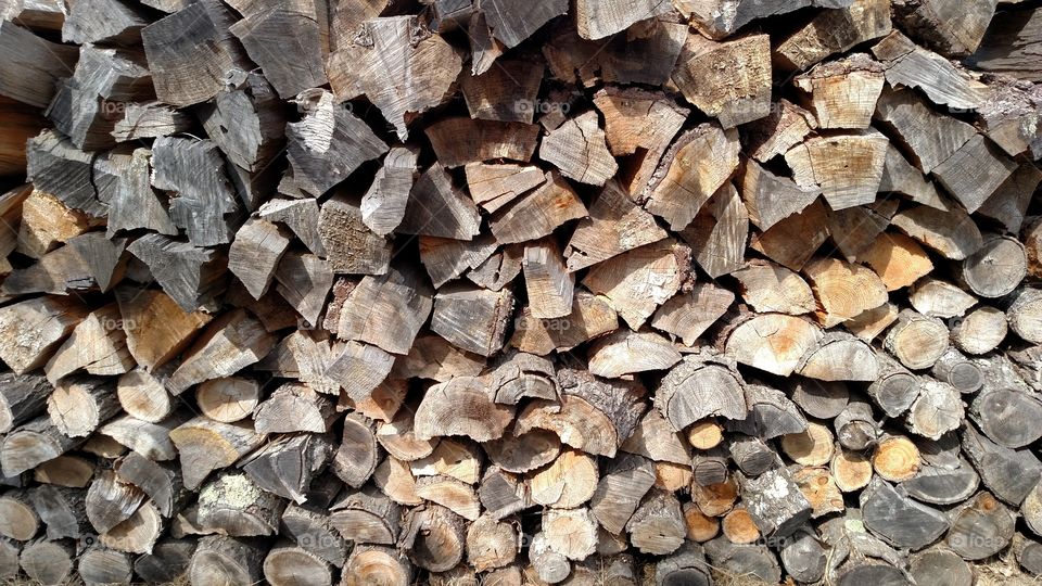 Firewood stacked bark facing up