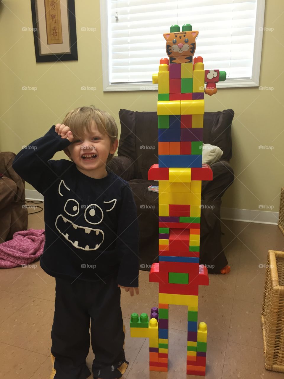Smiling cute little boy with building blocks