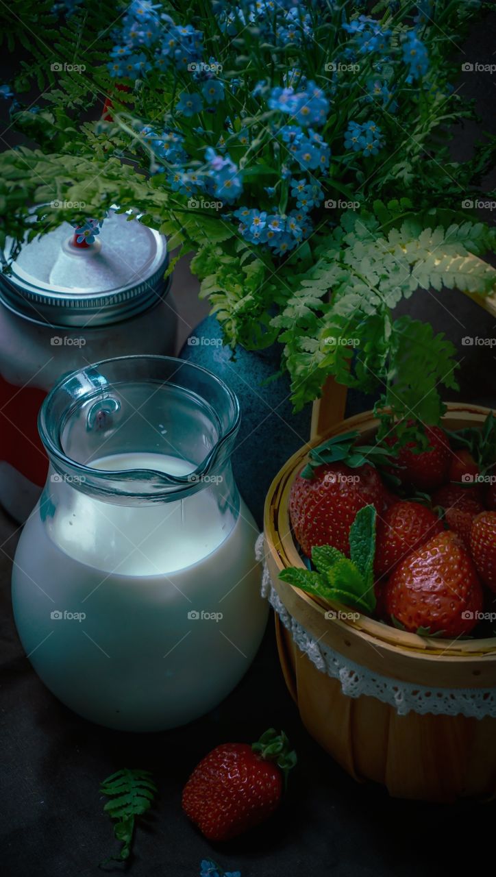 still life of strawberries, milk on a dark background