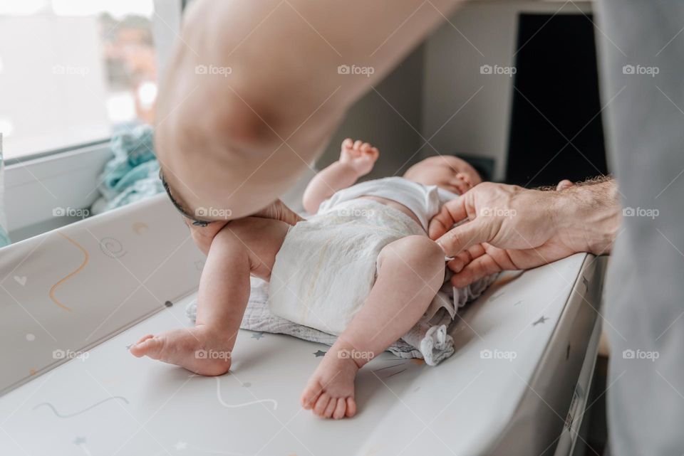 Close-up shot of father changing baby's diaper