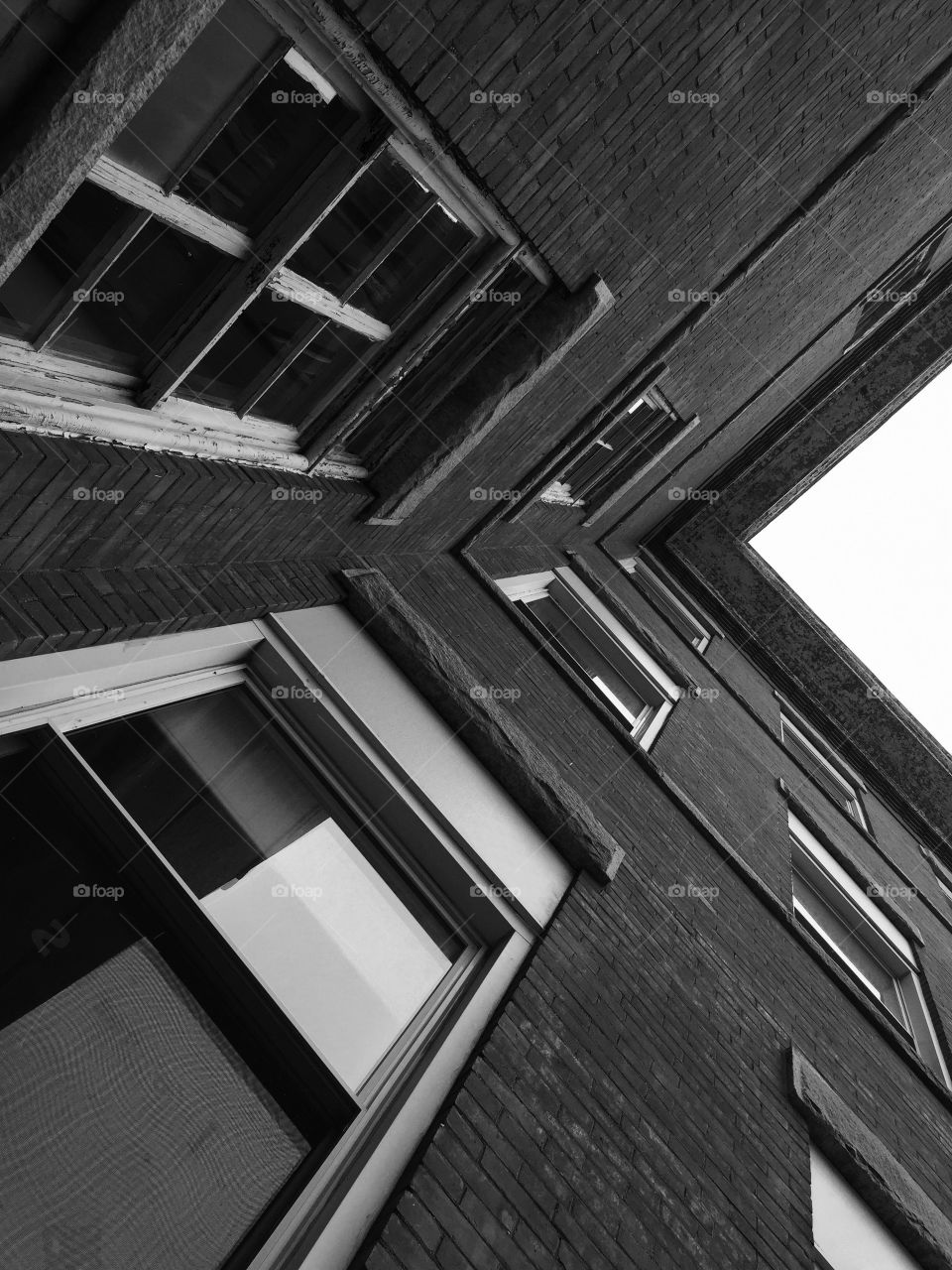 School building . Corner of a school building looking up In black and white