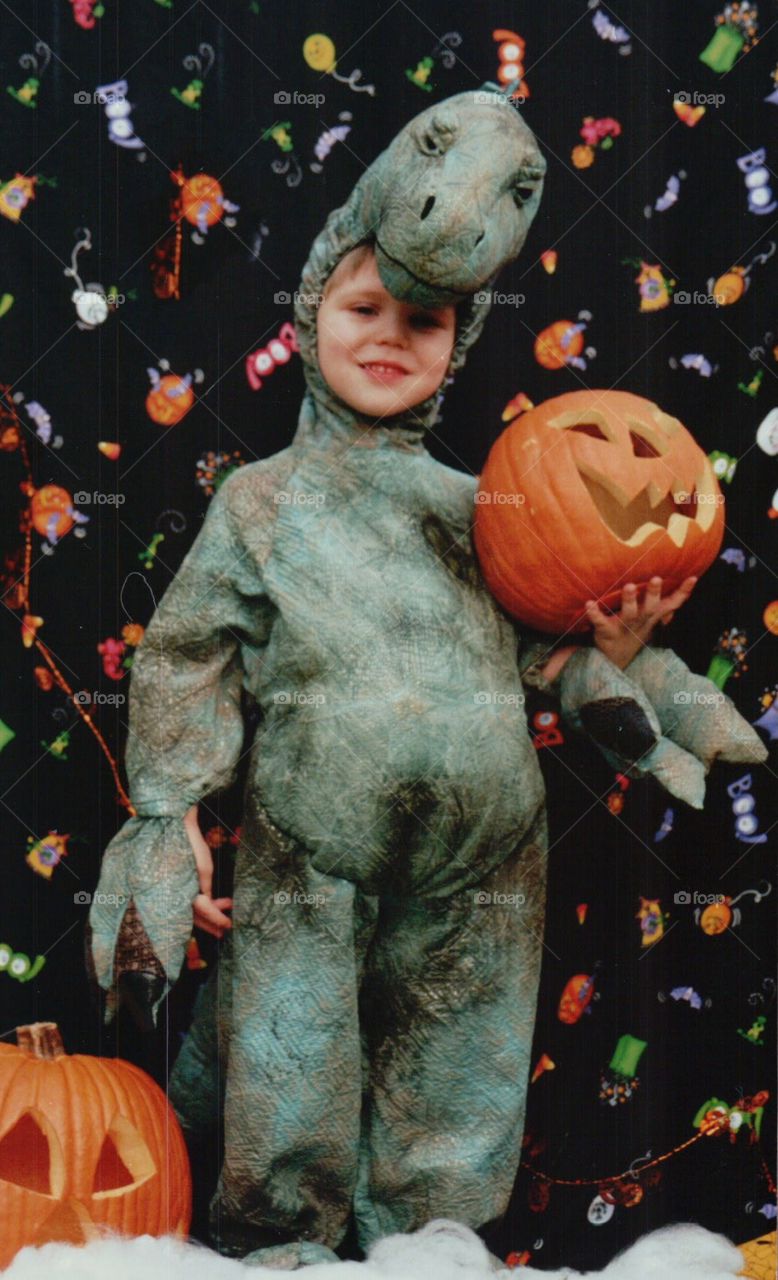 Toddler in a dinosaur Halloween costume 