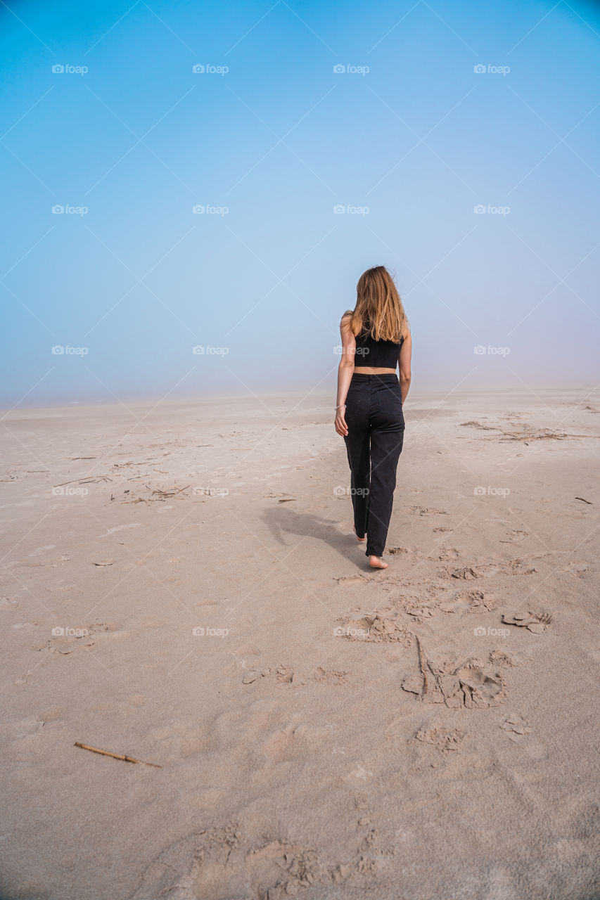 Walking on the beach during a summer morning.