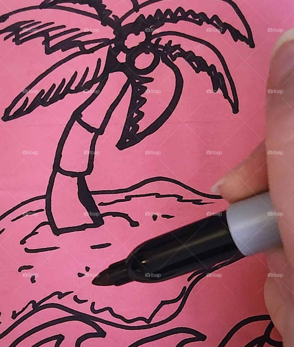 hand drawing a palm tree on a desert island because art offers a way to escape without leaving home