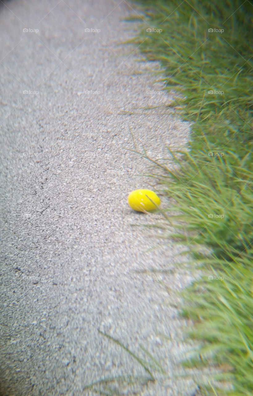 yellow ball in the sidewalk