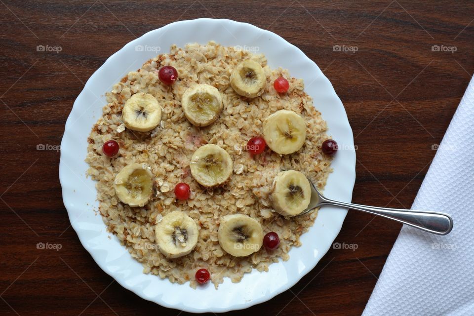 tasty oat meal with banana on a plate top view table background healthy food