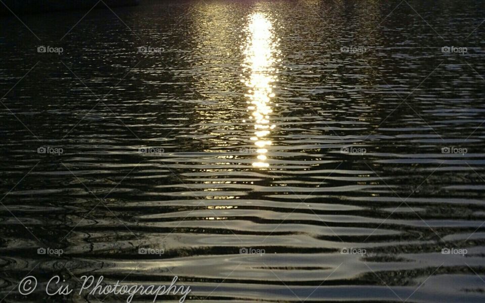 Sun set at the water in the park