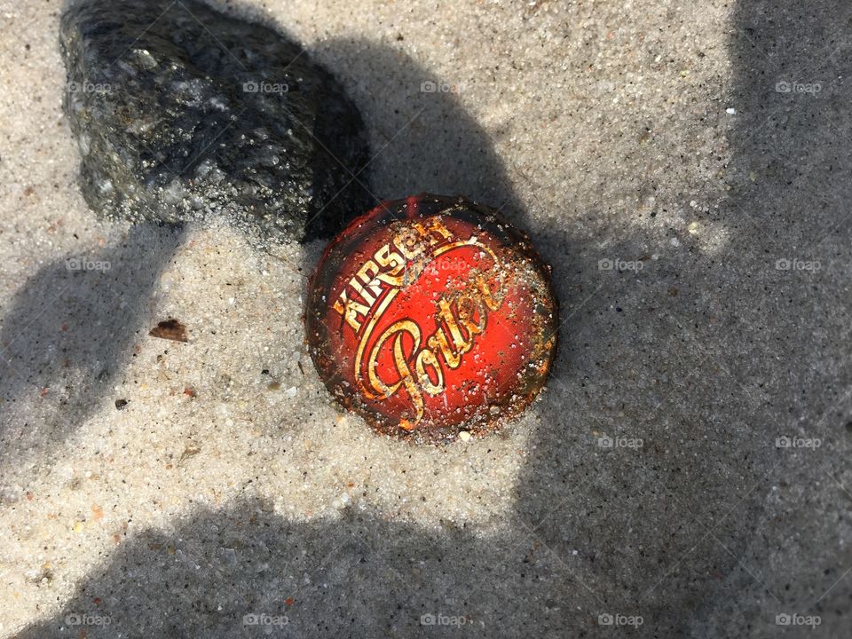 Rusty bottle top on beach