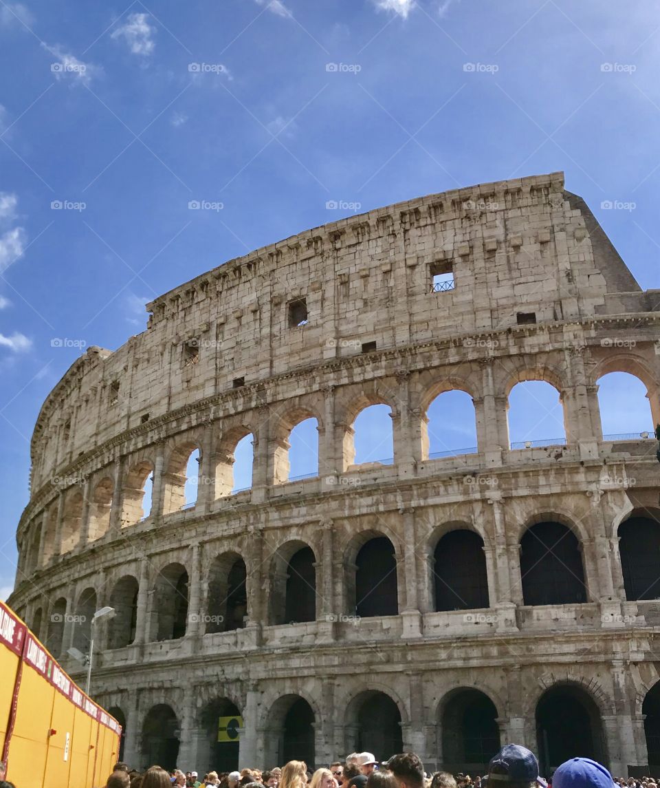 A close shot of the coliseum in Rome on a very Sunday day in Italy blue sky Romans 