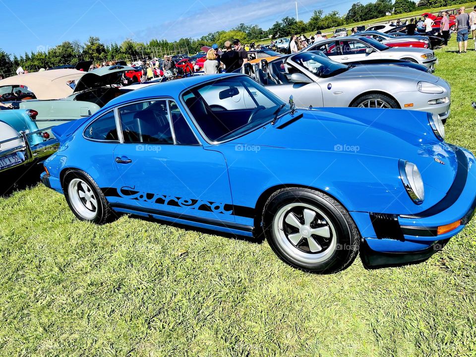 Porsche 911 Carrera on display at a social gathering for owners and enthusiasts. 