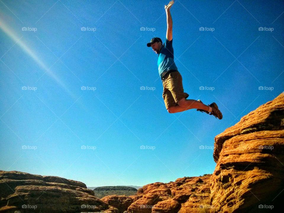 leap of faith. jumping off the red rock