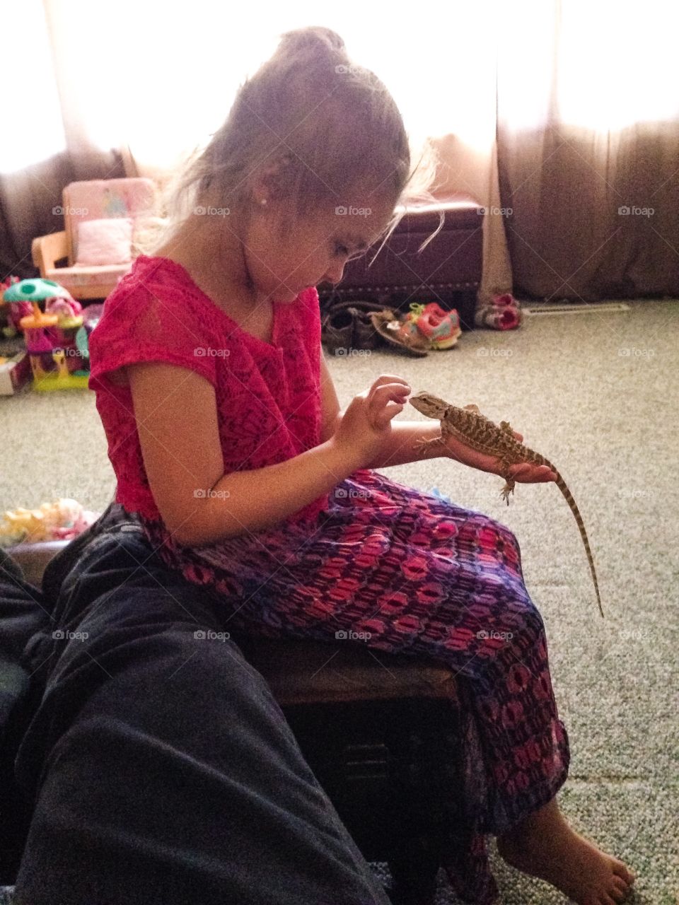 Girl holding lizard