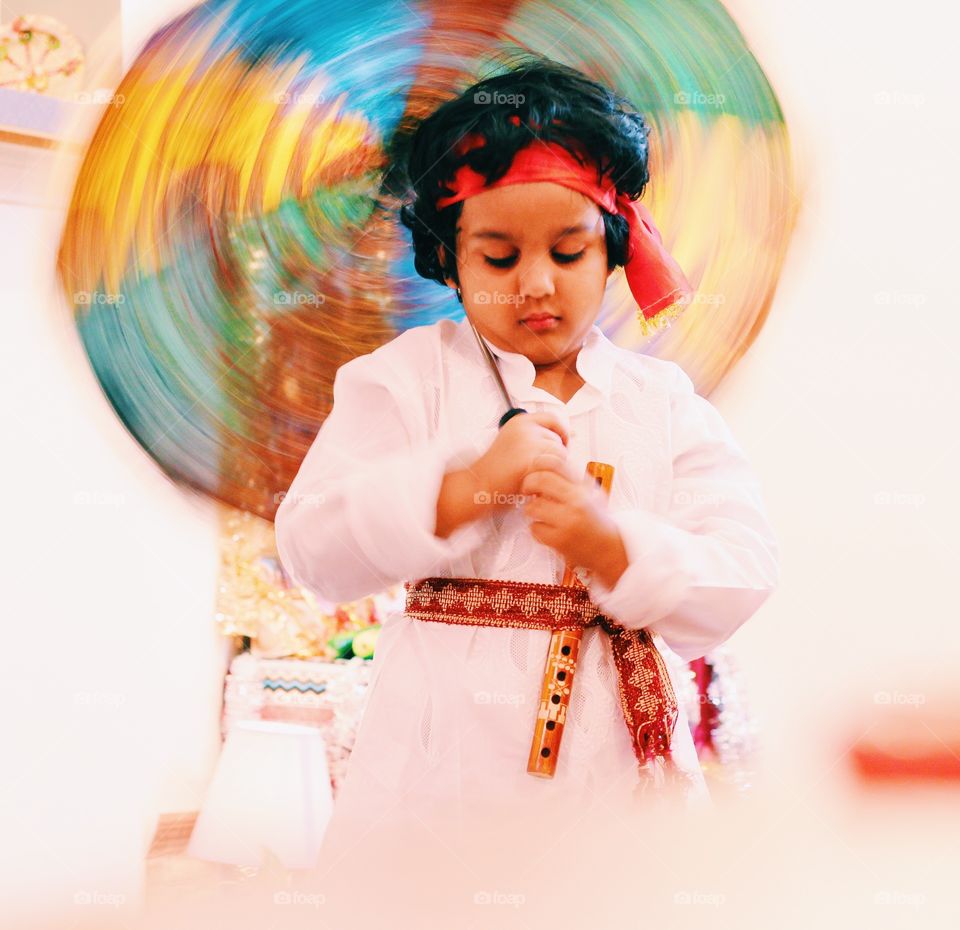 Indian kid dressed in traditional dress and celebrating festive season 