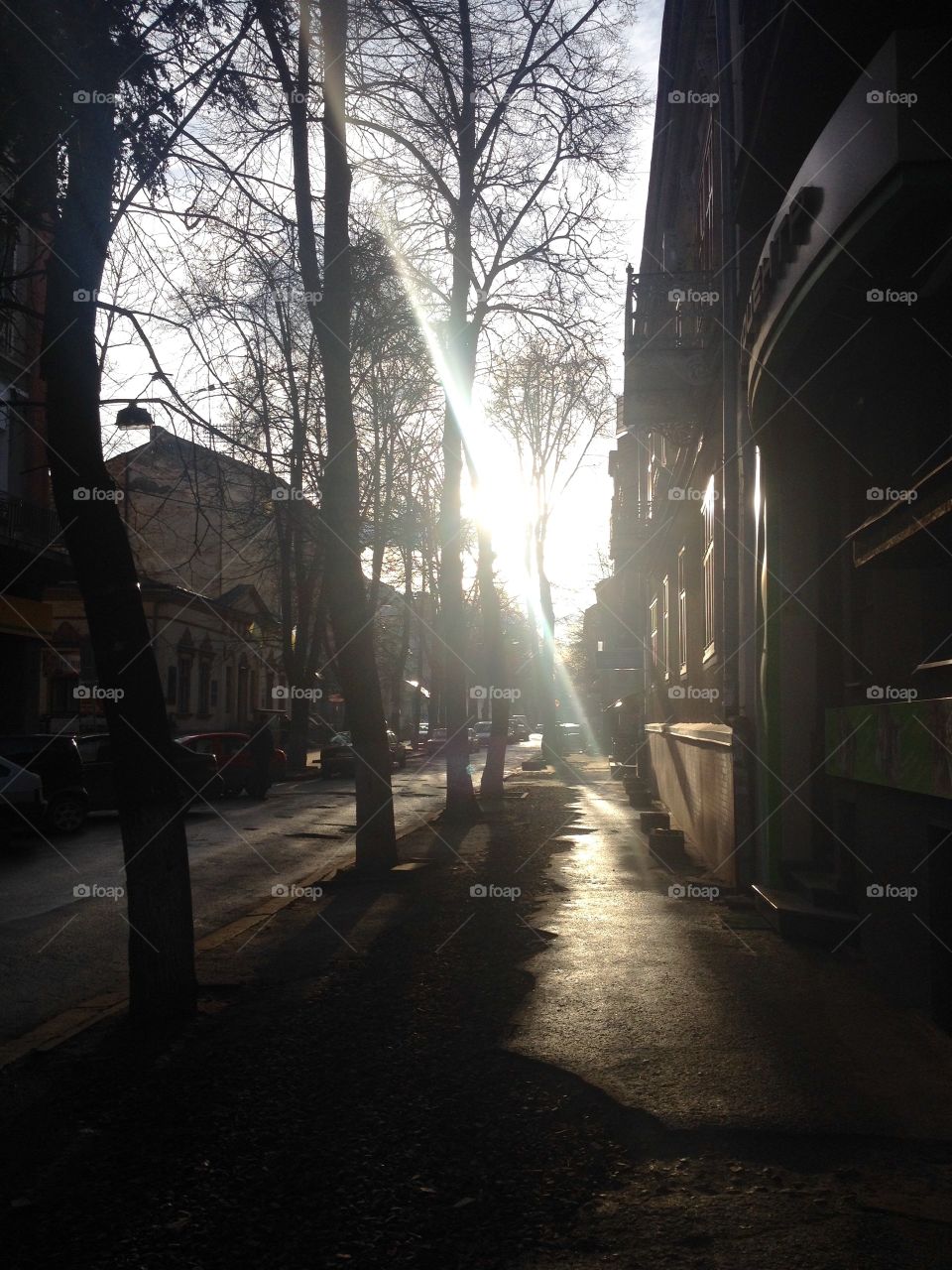 Sun shines on the street and blindes