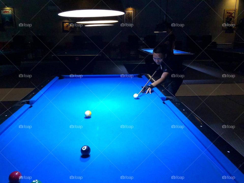 My colleague playing some billiard at night