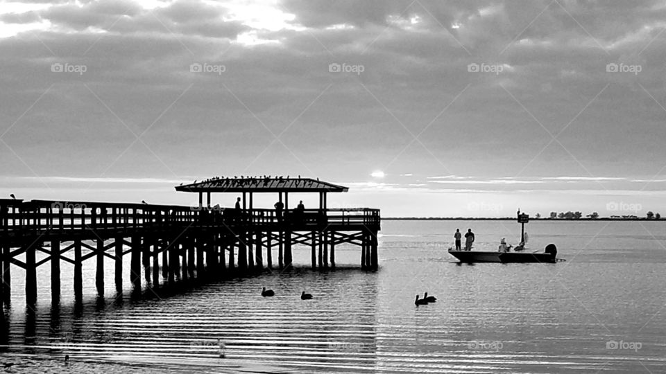 The pier during a black and white sunset