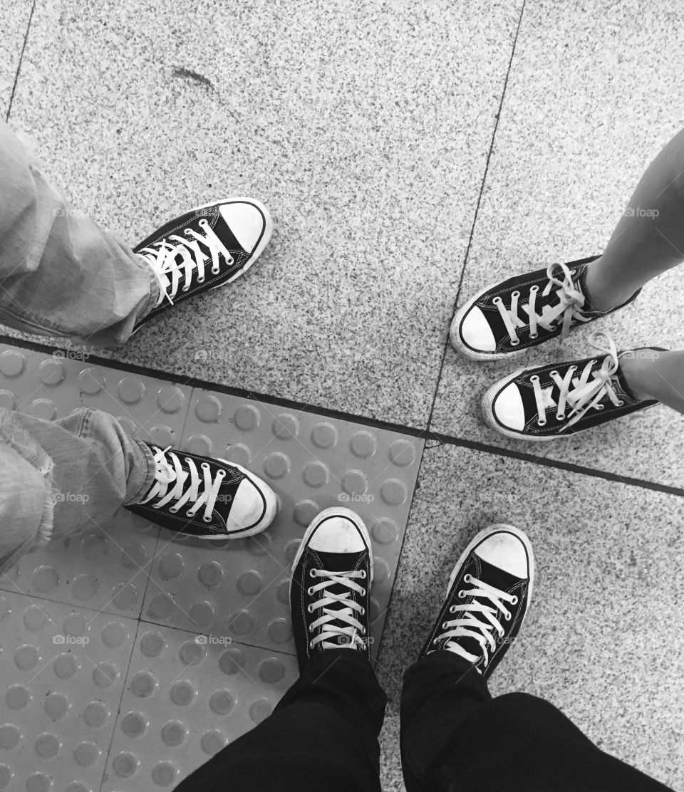 Three People Wearing Canvas Shoes