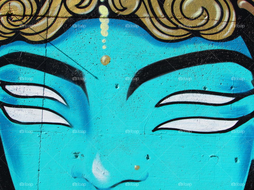 street art of a alien with four White eyes