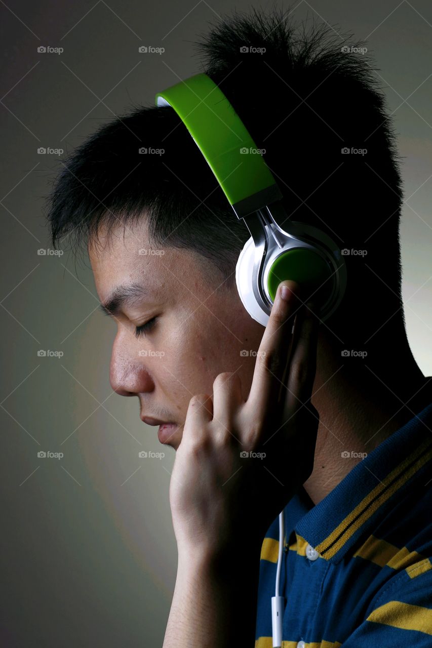 Close-up of teenage boy listening music