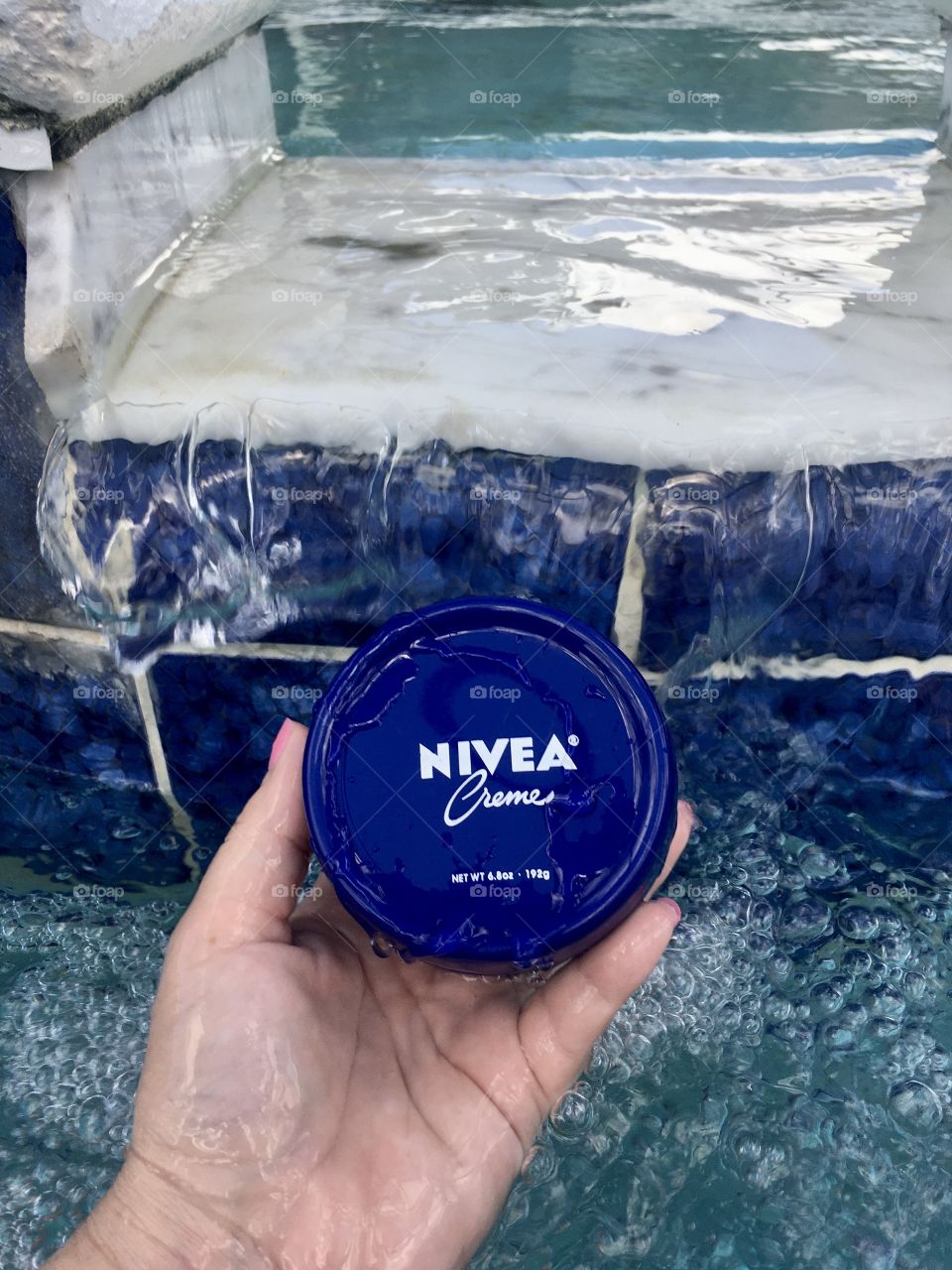 Nivea creme held by hand