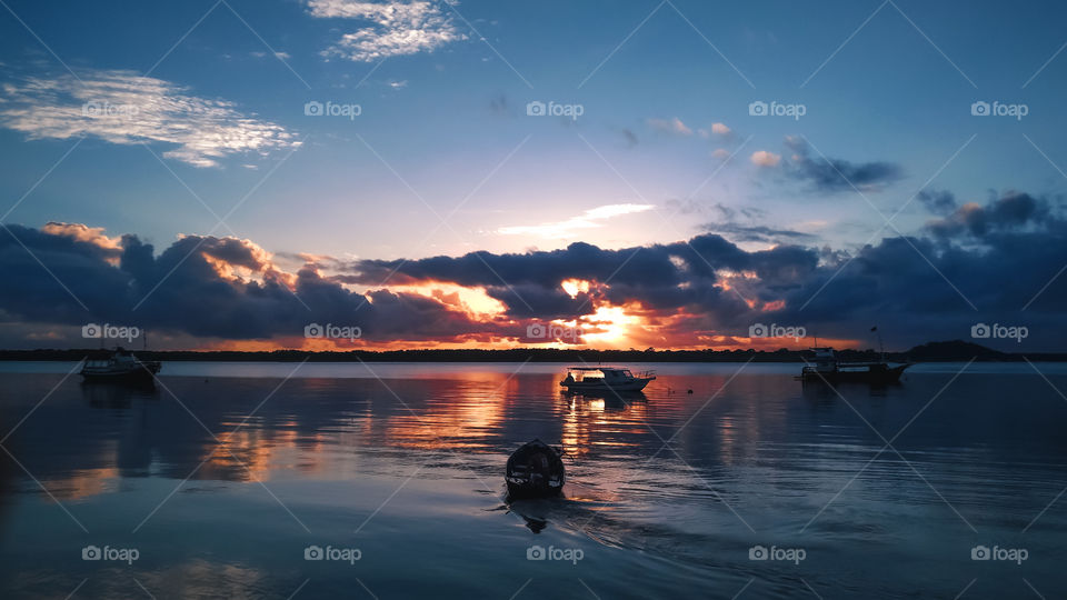 Beautiful Sunrise at Cardoso Island, Brasil / brazil. Beautiful sun, orange and blue contrast, fishing boats, symmetry.