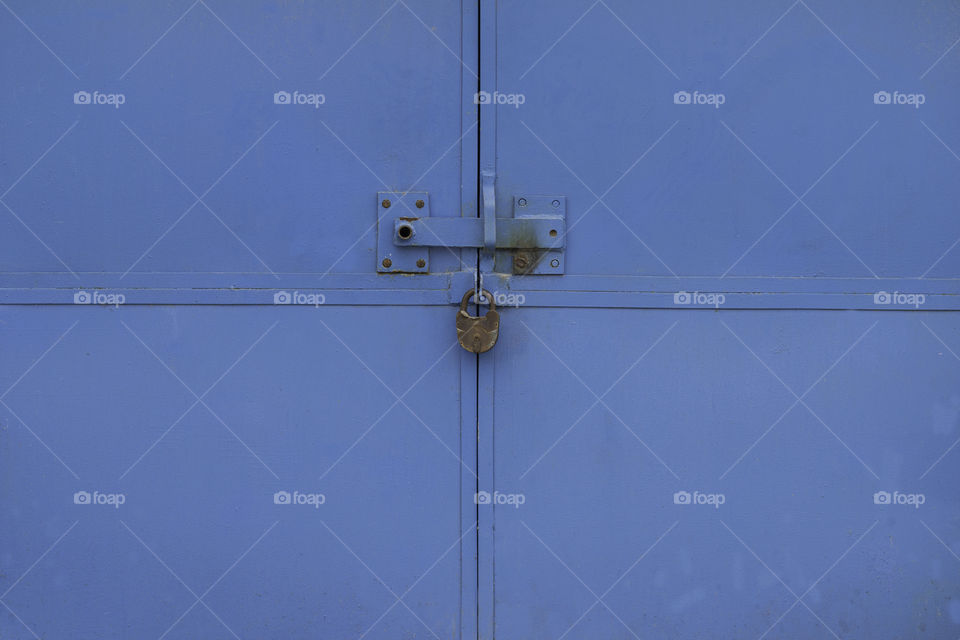 old metal gate with padlock.  close up