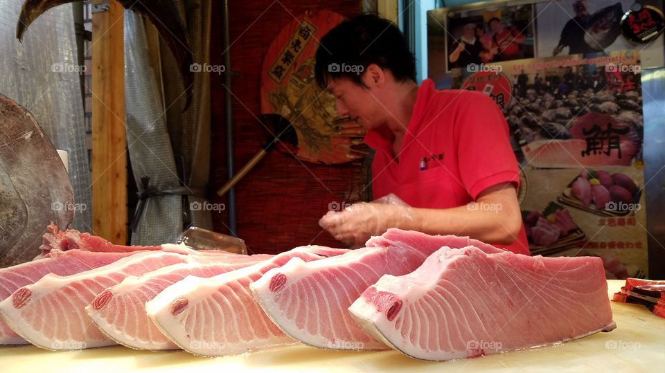 Sushi chef preparing tuna sashimi