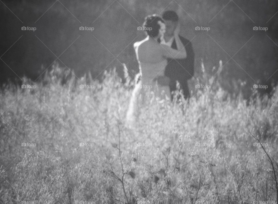 Newlyweds In A Field Of Flowers
