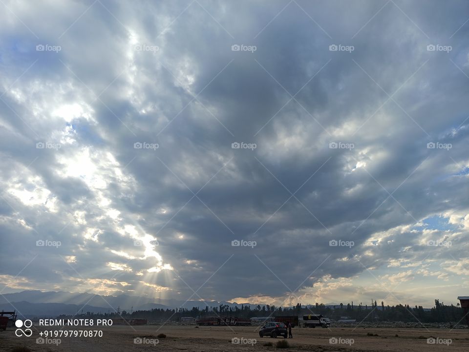 A beatiful Sunset scene (depicting Sun playing Hide n Seek with thick Clouds in Autumn Season) in Kashmir valley at Shopian town on Mughal Road on Shopian Side in the lap of  Mughal Road  National Highway in  Pirpangal Range