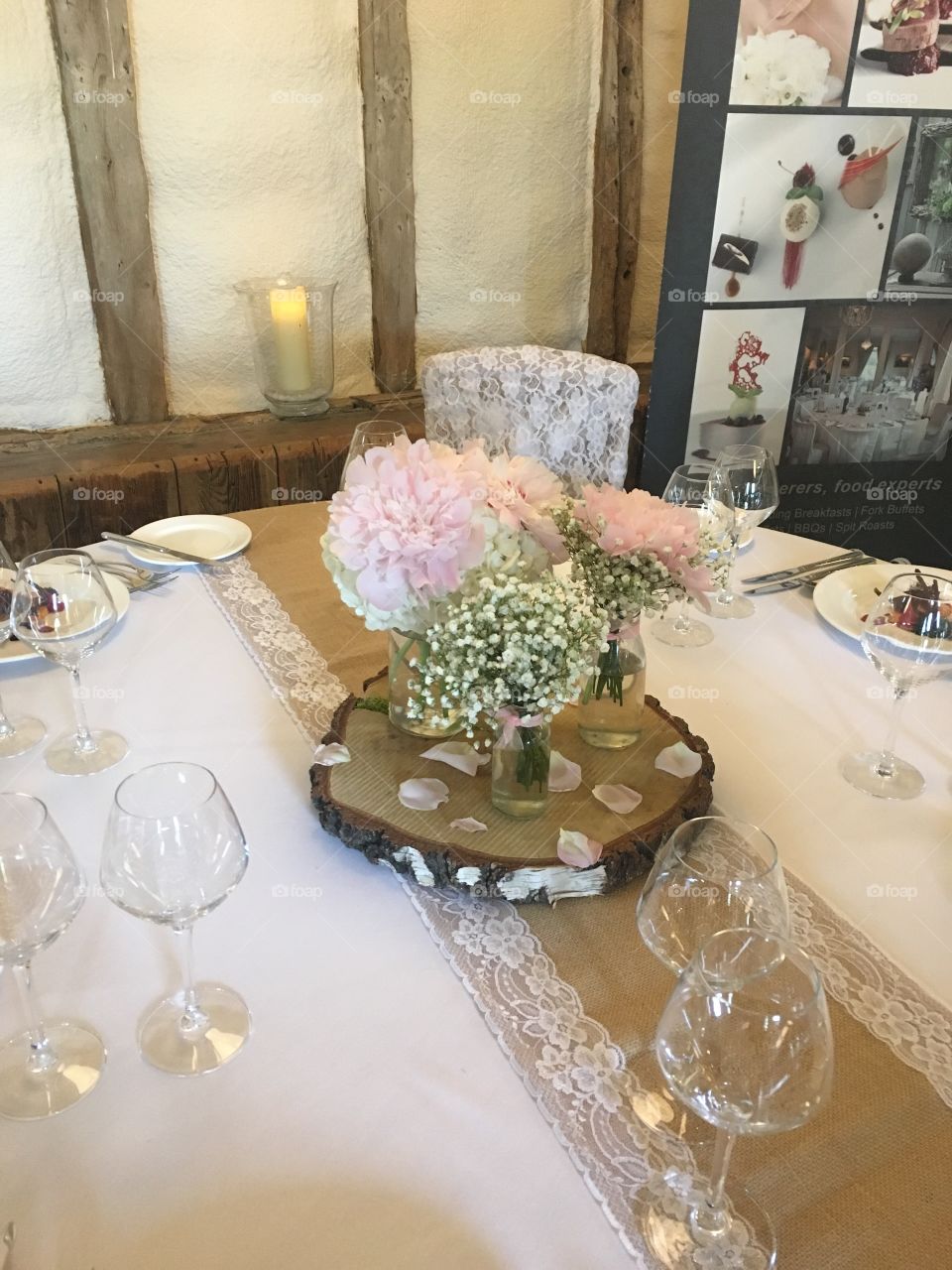 Wedding day at winters barns, table centrepiece log and gypsophila, win glasses and carnations  