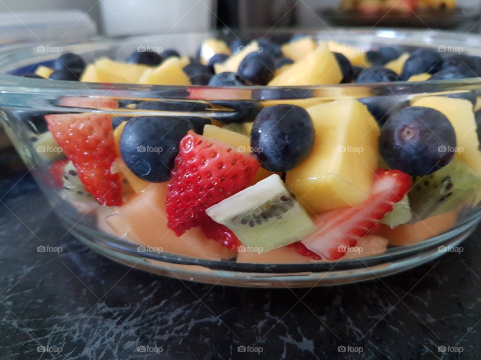 Chopped fruits in glass bowl