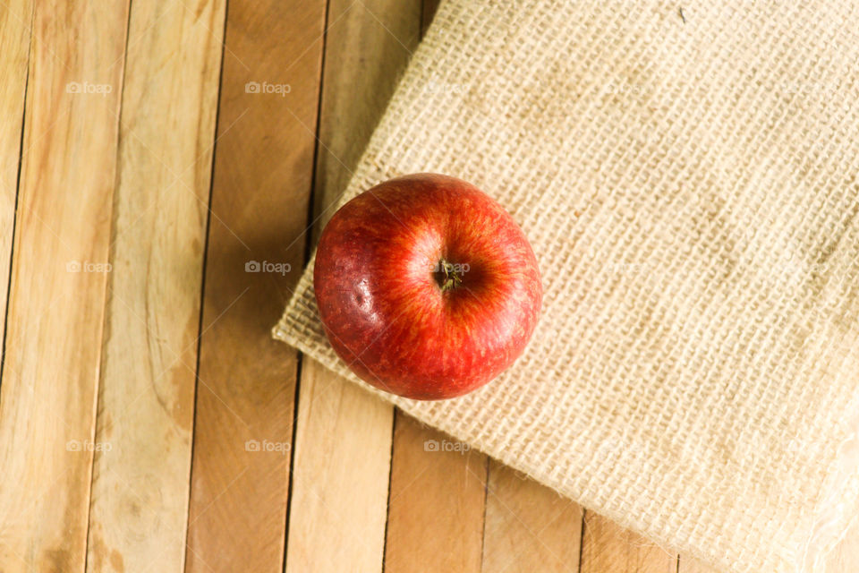Apple with wood and mat background
