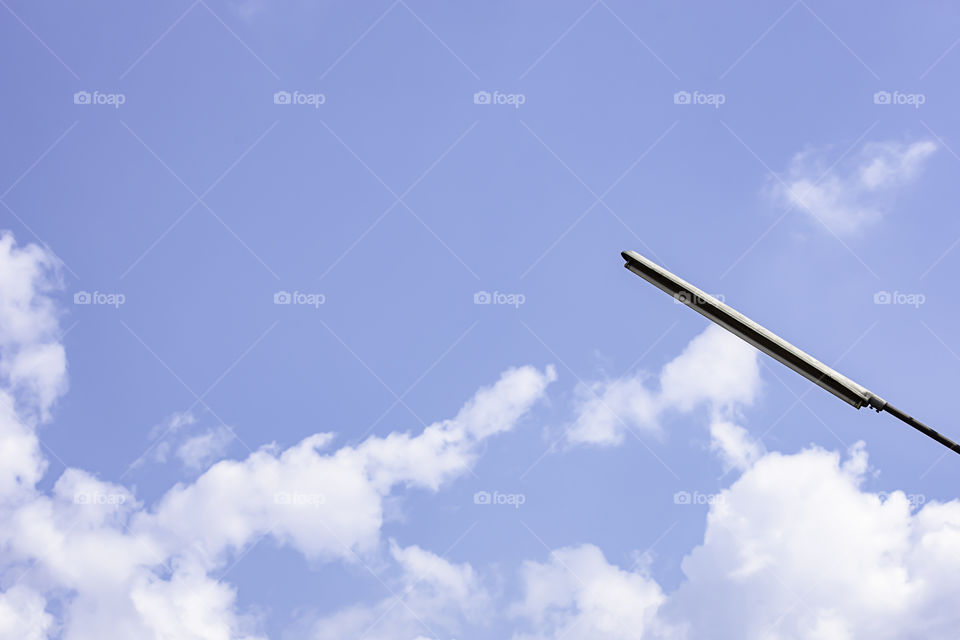 Street lamps with bright blue sky and cloud