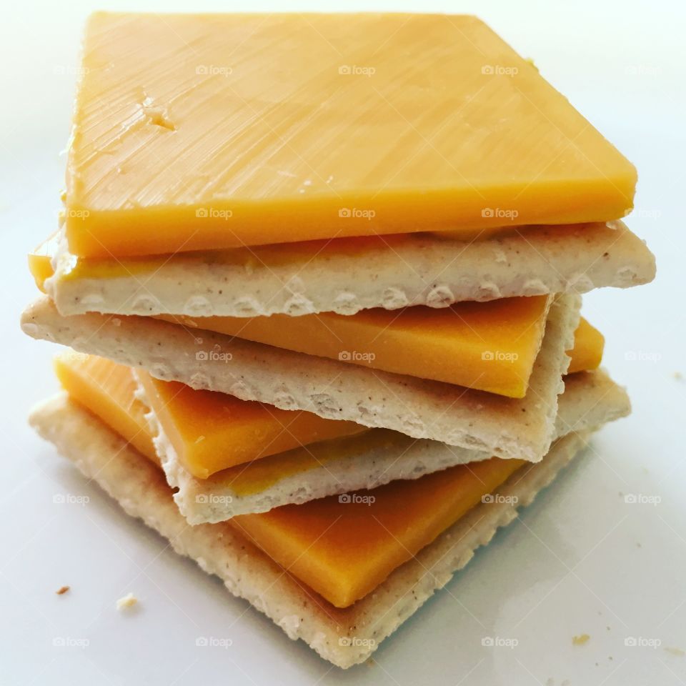 Saltine crackers with sharp cheddar and mustard.