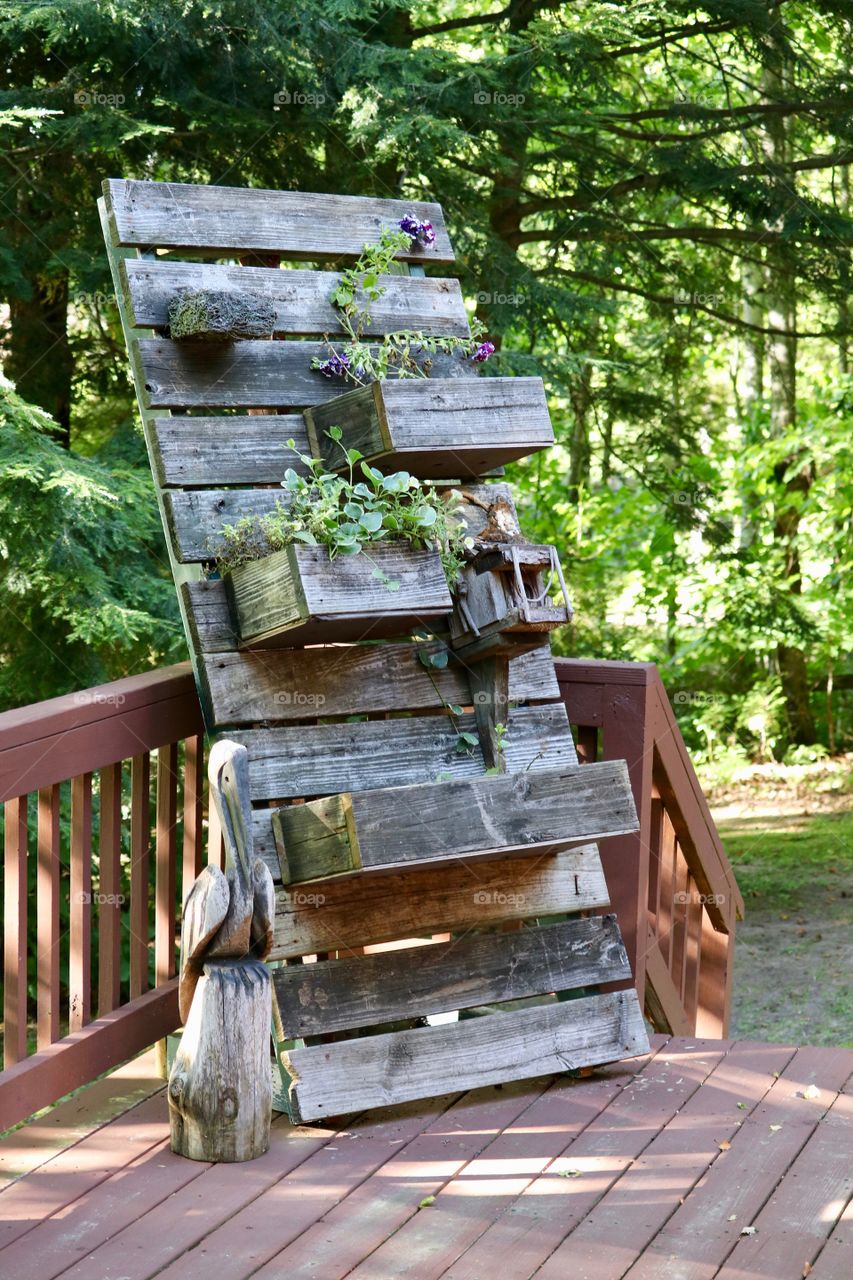 Transforming a wood pallet into an upright plant and flower garden showcase