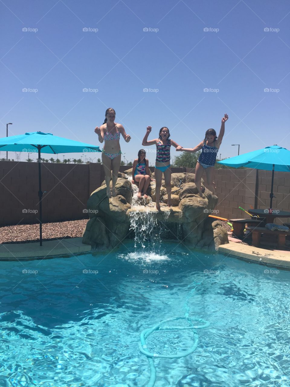 Summer Time Fun. Sisters enjoying their summer making a splash