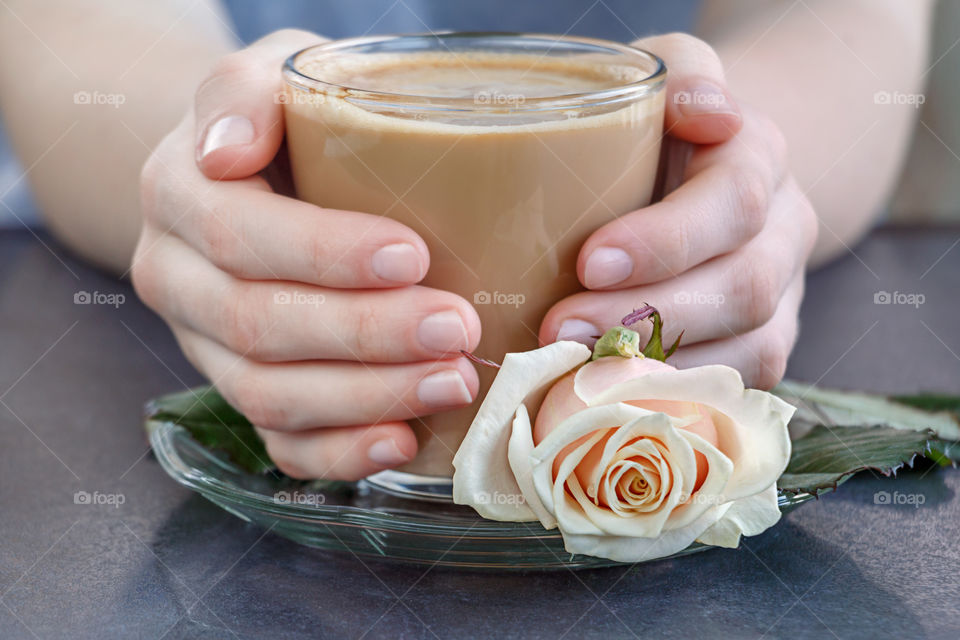 Coffee in cup with rose