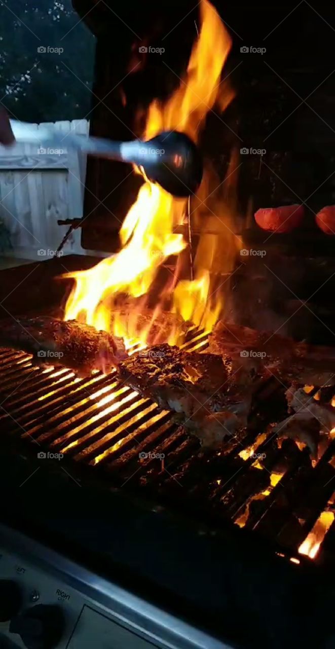 Cooking ribs on the grill,  also grilled tomatoes