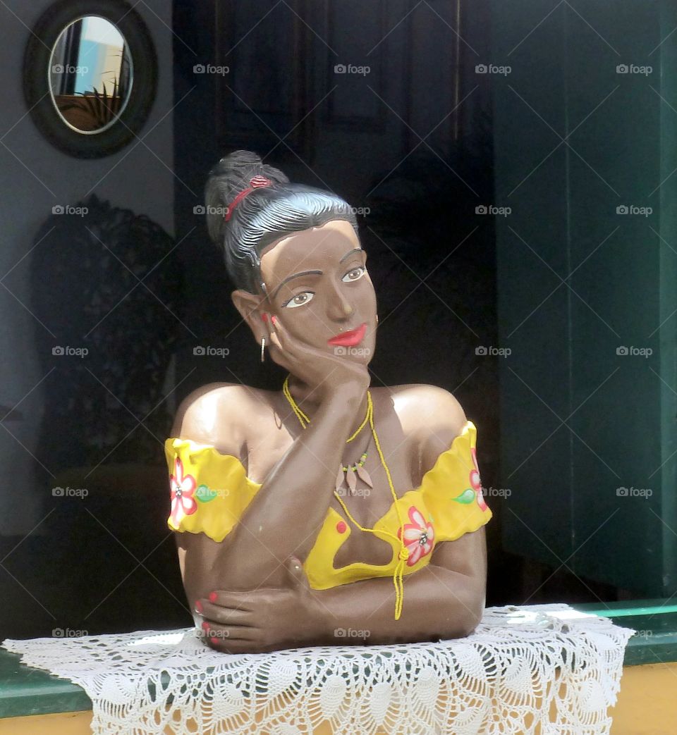 woman dreaming at her window in Salvador de Bahia