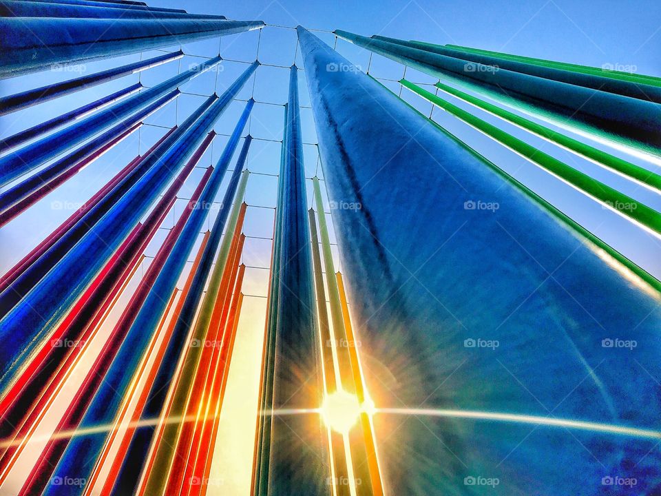 Color tall metal pipes in front of the sun