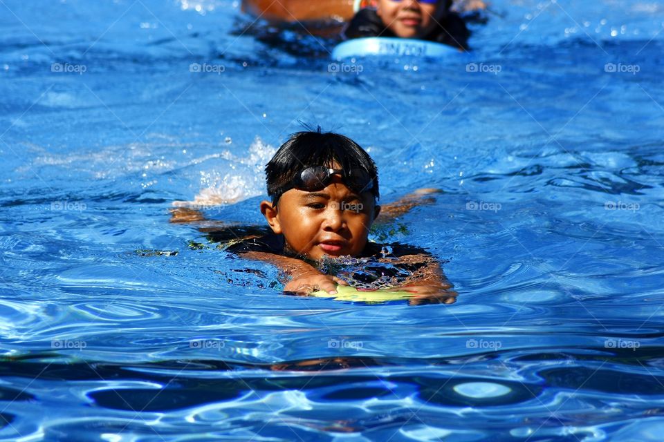 young kid in a swimming pool