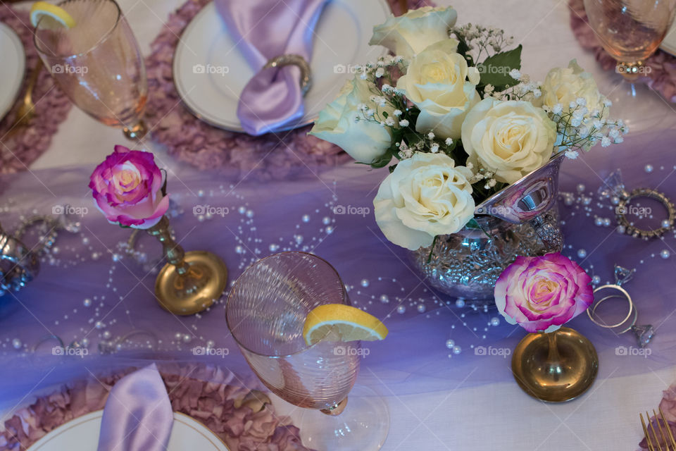 High angle view of a rose and empty glass