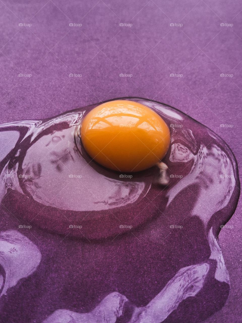 using complementary colors for an original idea, namely eggs with a yellow yolk on a purple background
