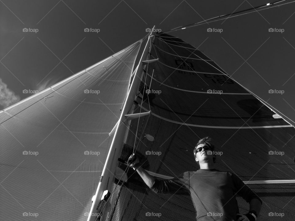 Man holding onto rigging