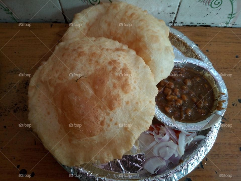 Famous Indian Street Food Chole Bhature also known as Chana Bhatura is one of the most popular Punjabi dish liked almost all over India. Chole stands for a spiced tangy chickpea curry and Bhatura is a soft and fluffy fried leavened bread.