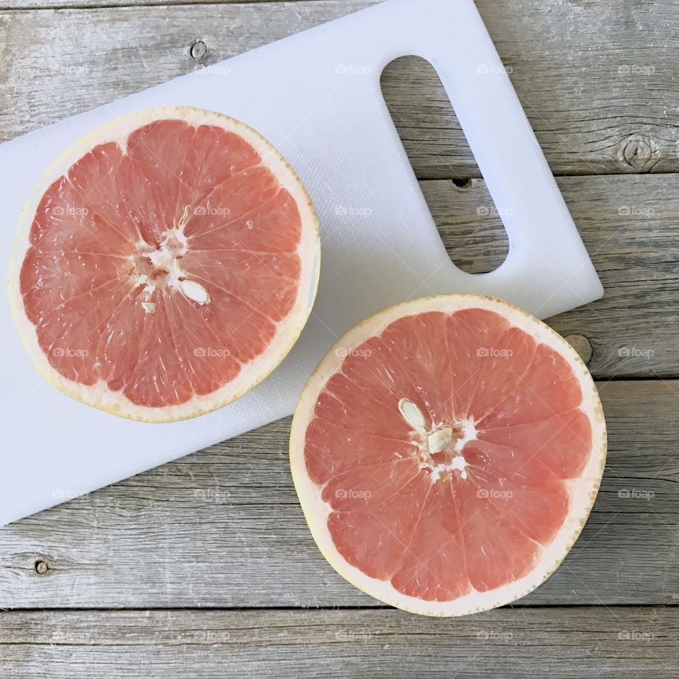 Citrus fruit with cutting board